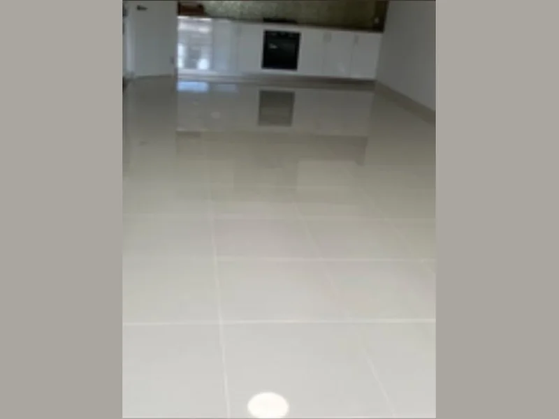 A large tiled living area polished to a reflective finish