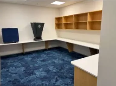 Office fit-out with blue commercial carpet tiles after cleaning