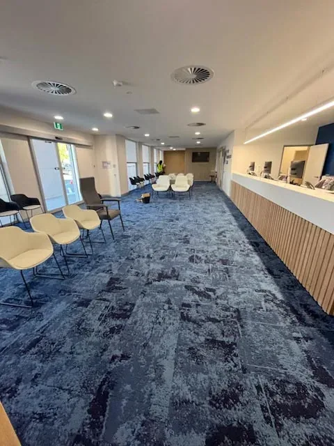 Patterned blue commercial carpet in a clinic waiting area after cleaning