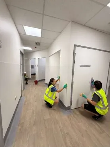 Living Fresh Cleaning team cleaning a clinic corridor