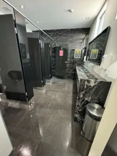 Commercial washroom with clean basins and polished floor