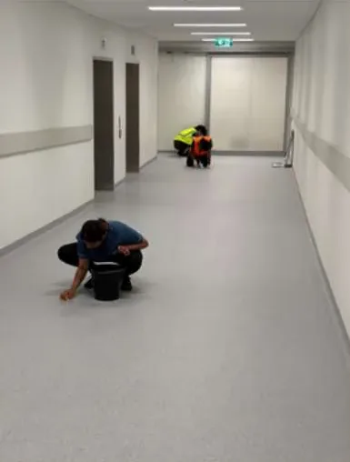 Cleaner mopping a long commercial corridor