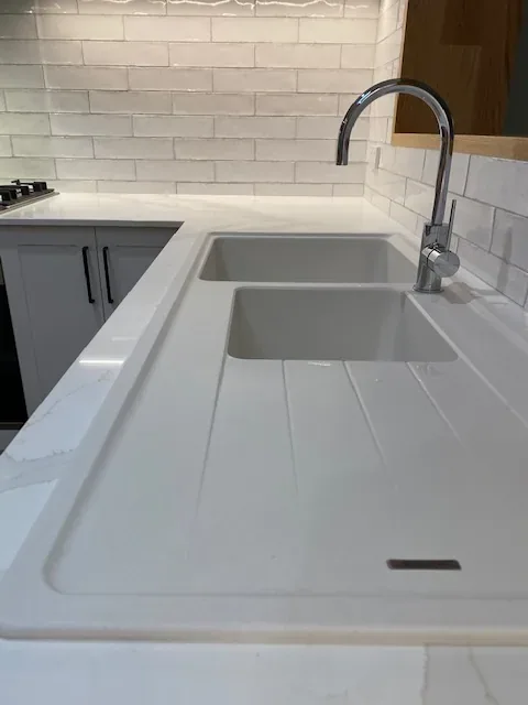 Clean kitchen sink, mixer tap and benchtop