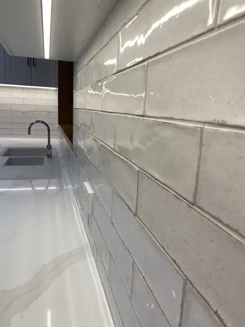 Marble-look benchtop and tiled splashback wiped clean