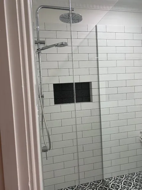 Shower with white subway tiles and clean glass screen