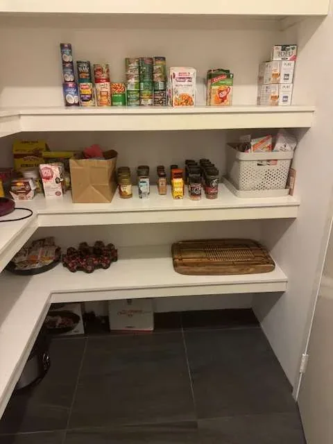Tidy walk-in pantry with clean shelves