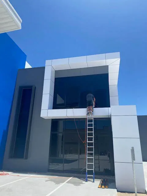 Exterior glass on a two-storey building with access ladder