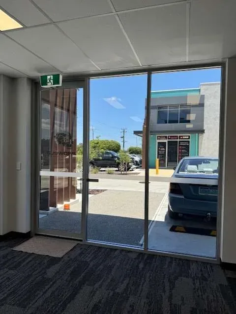 Clean glass entry doors looking out to the street