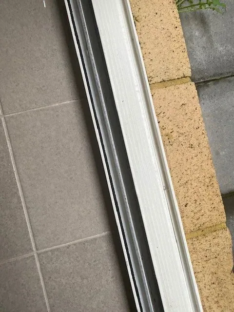 Sliding door track cleared of dust and grit