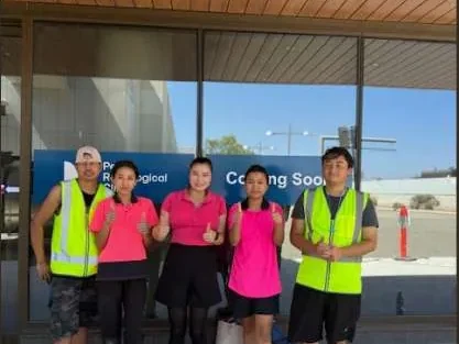 Five Living Fresh cleaners in hi-vis and uniform outside a new clinic
