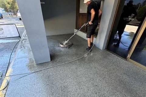 A Living Fresh cleaner pressure washing an exposed-aggregate floor