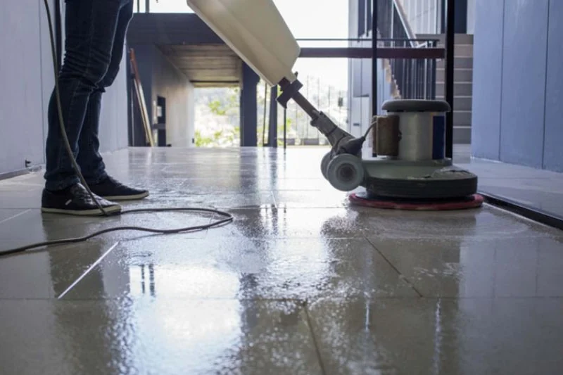 A floor scrubber polishing tiled flooring